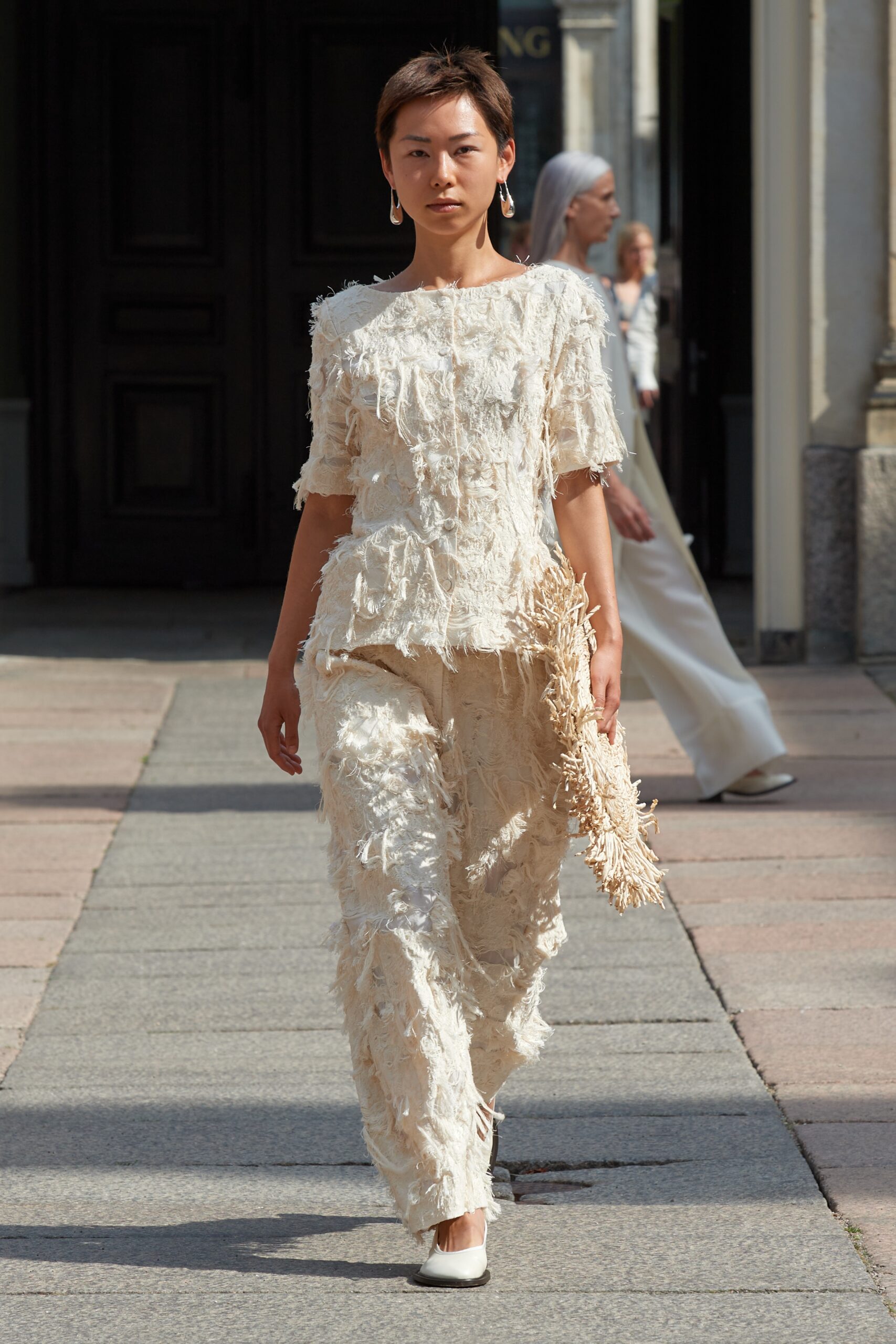 Model wearing Mark Kenly Domino Tan SS25 during Copenhagen Fashion Week