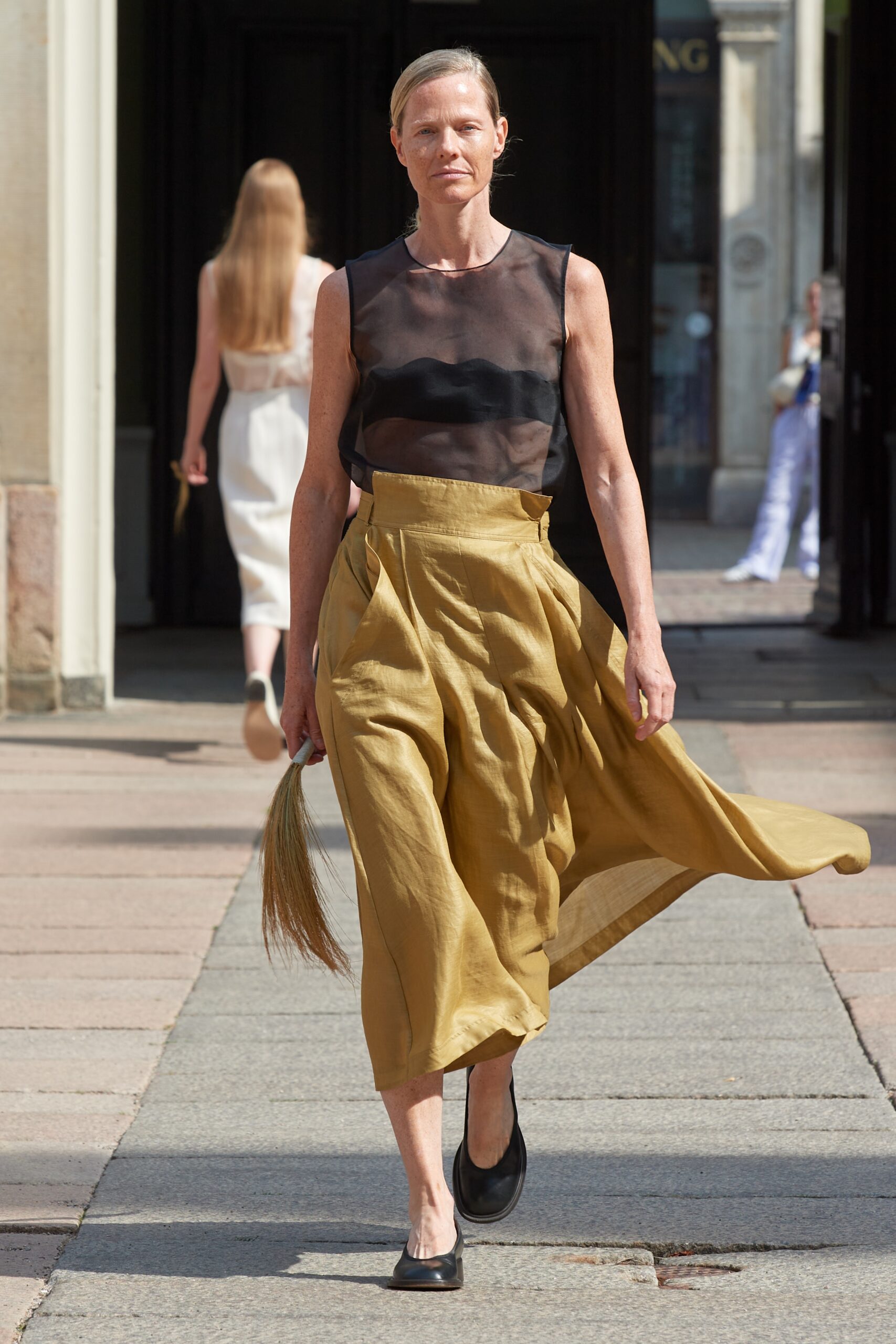 Model wearing Mark Kenly Domino Tan SS25 during Copenhagen Fashion Week