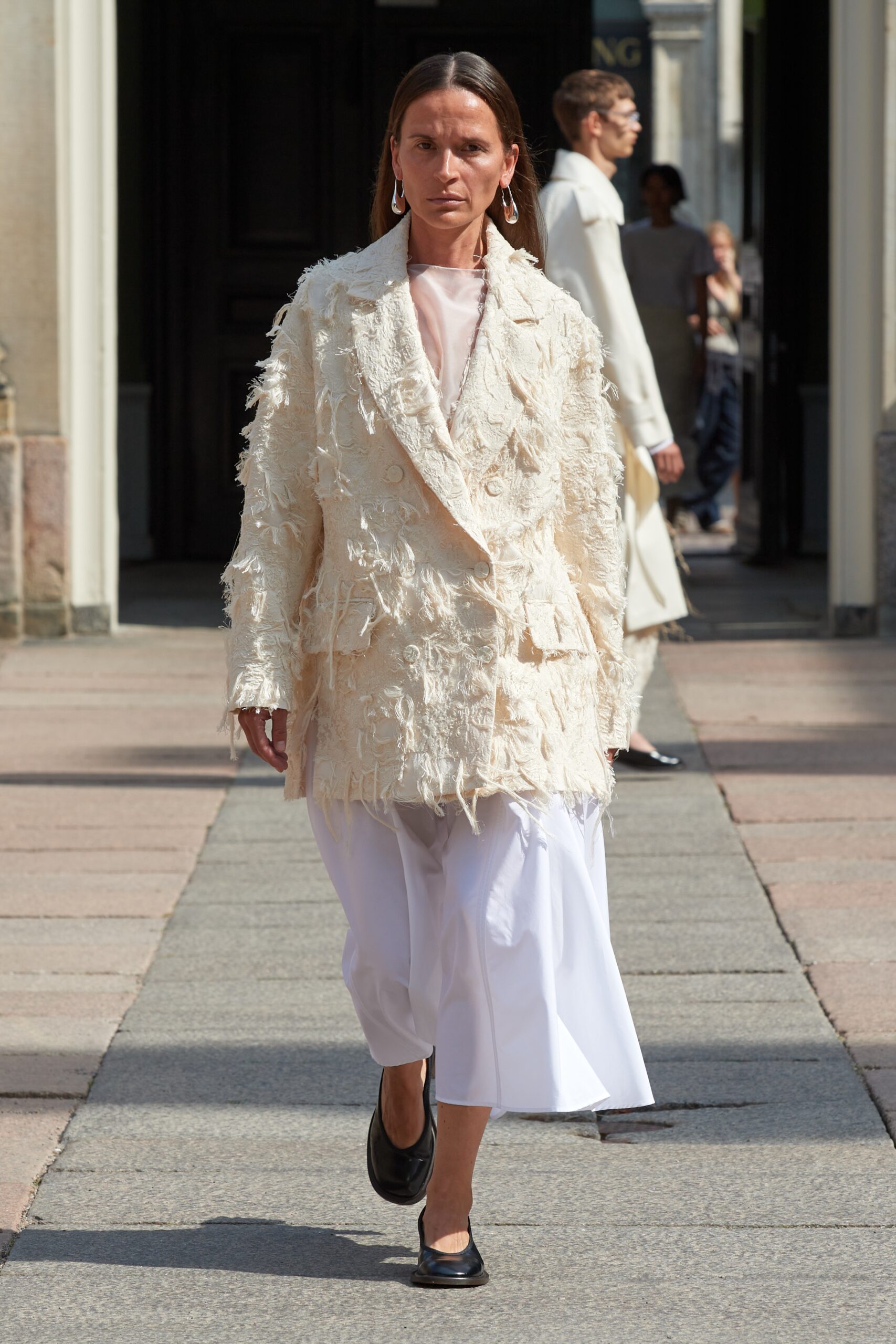 Model wearing Mark Kenly Domino Tan SS25 during Copenhagen Fashion Week